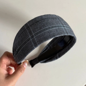 Detail of grey plaid fabric headband with non-slip lining and soft texture