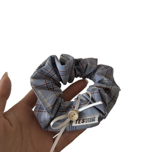 Blue plaid scrunchie with white ribbon bow and wood button for high ponytail hairstyles