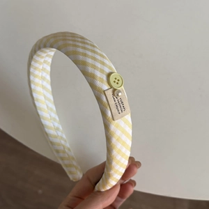 Detail of yellow plaid headband with button pearl accents and fabric tag design