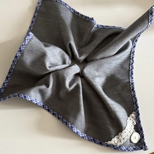 Detailed macro of grey cotton scrunchie with lace trim and blue checkered border edge