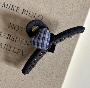Detail of elegant blue plaid heart motif on large fabric hair claw clip accessory