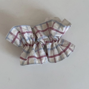 Détail de la bordure en dentelle et du motif à carreaux sur l'accessoire à cheveux