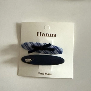 Blue plaid hair clips with bow detail on white display card for elegant styling