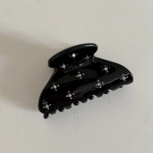 Elegant black glossy hair claw with shimmering rhinestones for women's hairstyles