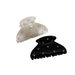 Sparkly black and cream hair claw clips with star-shaped rhinestones for women