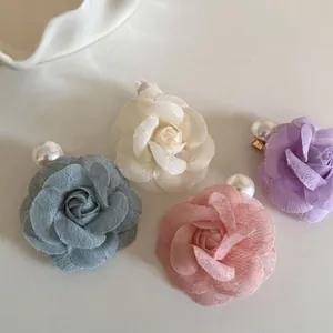 Elegant floral hair clips with fabric petals and pearls in pastel colors for women