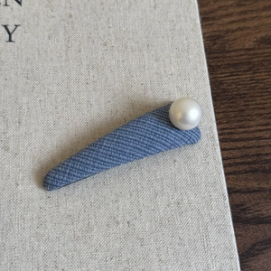Denim blue fabric hair clip with a white pearl accent in a stylish Korean minimalist design