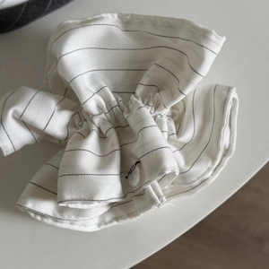 Striped white scrunchie with Paris button detail in a minimalist Korean athletic style