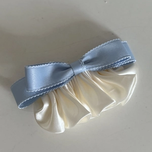 Retro light blue satin bow hair clip with cream ruffled pleats and scalloped edges