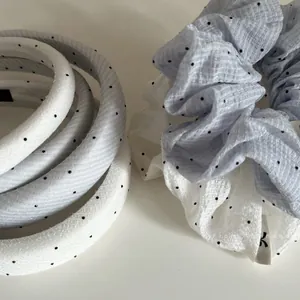 Close-up of blue seersucker scrunchie and polka dot padded headbands set for hair styling