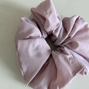 Detail view of large lavender fabric scrunchie with pleated texture for everyday hairstyles