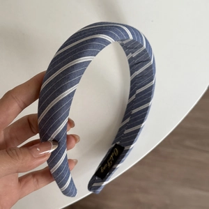 Close-up of blue and white striped fabric scrunchie with detailed twill cotton texture