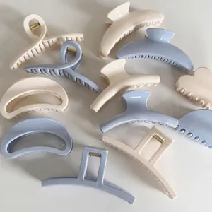 Matte cream and blue shark hair clips in crescent, rectangular, and heart shapes
