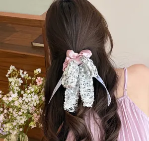 Pink satin hair scrunchie with silver sequins and a 'mini' branded bow detail