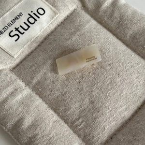 Macro shot of ivory cream cellulose acetate baguette clip with France Handmade engraving