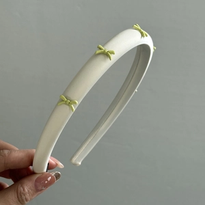 Sweet off-white leather headband with four pastel green ribbon bows for women's hair styling