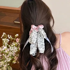 Pink satin hair scrunchie with large silver sequin bow and mini print ribbons