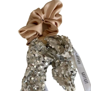 Champagne satin hair scrunchie with silver sequin mesh bow and ribbon tail accessory
