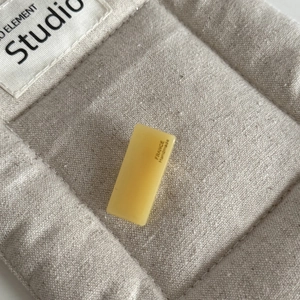 Macro shot of yellow acetate hair clip featuring FRANCE Handmade gold lettering