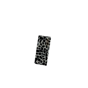 Minimalist black and white giraffe print acetate hair clip with elegant golden logo label