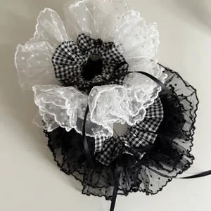 Classic black and white gingham hair scrunchies with dotted lace edge and ribbon bows