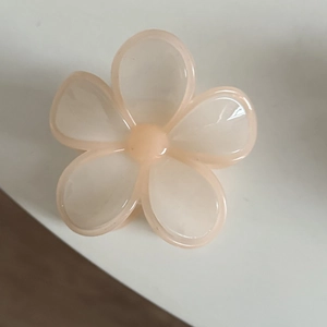 Translucent peach flower hair claw clip with a five-petal design and smooth finish