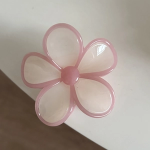 Macro shot of sweet pink flower hair claw with translucent pearlescent jelly finish