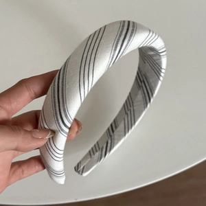 Détail du serre-tête rembourré épais avec un tissu à rayures noires et blanches chic