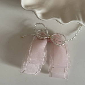 Pink organza bow hair clip with beaded butterfly detail and golden metal bead