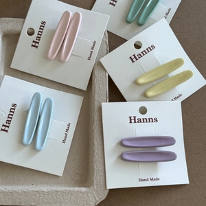 Detail of macaron color hair clips set on display cards with matte glaze finish