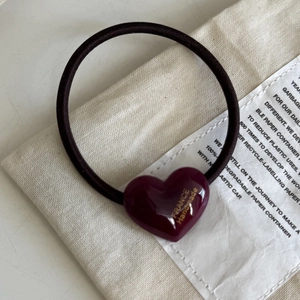 Elegant deep red heart hair tie with France Handmade gold lettering on canvas background