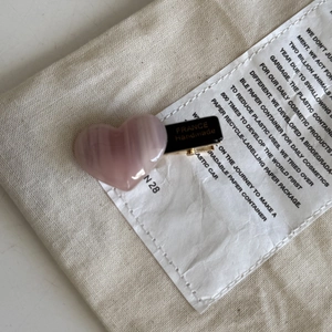 Pink heart-shaped acetate hair clip with golden France Handmade stamp on a black metal base