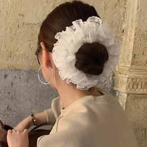 Elegant white layered organza lace scrunchie shown in a stylish hairstyle for women