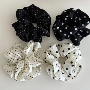 Detail view of four-piece set of French style polka dot chiffon hair scrunchies in black and white