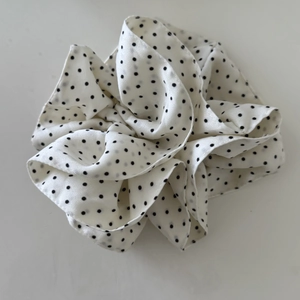 French polka dot scrunchie in cream and black chiffon with pleated layers on white background