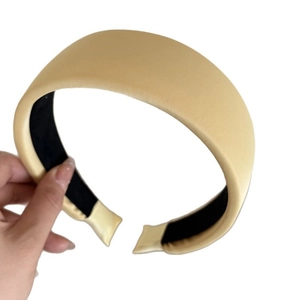 Champagne gold satin padded headband for women featuring a thick wide design and nonslip lining