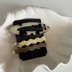 Three-piece acetate hair clip set with marble pattern and wave designs on a display card