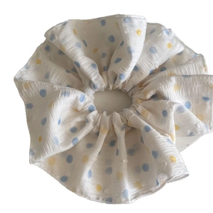 Minimalist white polka dot scrunchie with blue and yellow prints for stylish hair styling