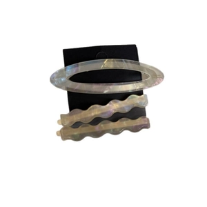 Iridescent acetate wave hair clip set with pearl finish on a black display card