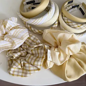 Yellow plaid headband and scrunchie set in creamy tones for elevated hairstyles