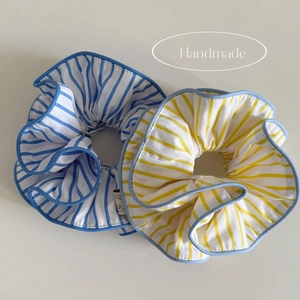 Blue and yellow striped fabric hair scrunchies with light blue trim and handmade label