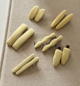 Close-up of cream yellow fabric hair clips with soft velvet texture and metal grip