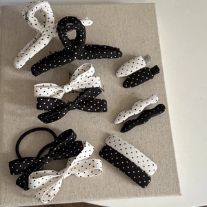 Polka dot hair accessories set featuring black and white bows, clips, and scrunchies