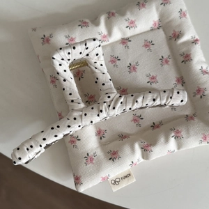 French style white hair claw clip with black polka dots on a floral quilted pad