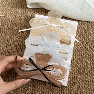 Three acrylic bow hair claws in champagne, white and brown colors with silk ribbons