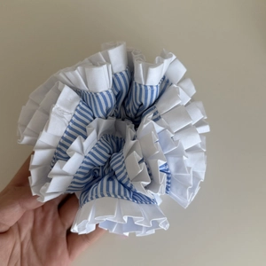 Detailed macro view of blue striped and white layered pleated oversized scrunchie