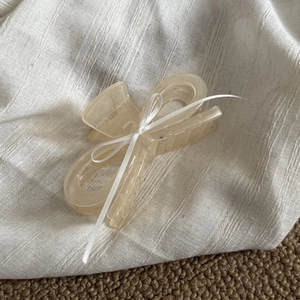 French acrylic bow hair claw clip in cream with elegant white ribbon streamer decor