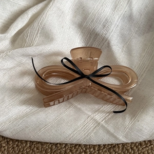 French acrylic bow hair claw clip in amber brown for elegant ballet style hair styling