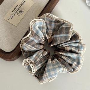 Detailed view of blue plaid scrunchie with lace trim and vintage checkered pattern