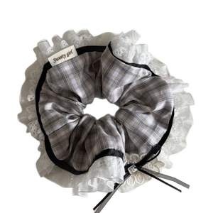 Plaid floral scrunchie with lace edges and Good Luck charm on a white background